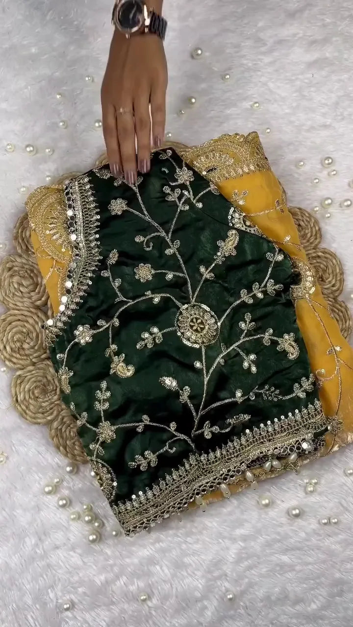 Mustard Yellow Velvet Saree Draped with Exquisite Silver Zari Embroidery and Mirror Work, Perfectly Complemented by a Rich Forest Green Velvet Blouse Featuring Matching Heavy Embellishments