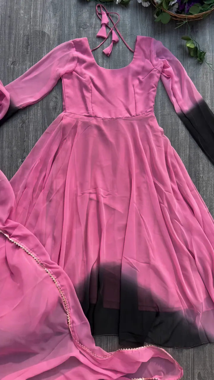 Pink to Black Ombre Flowing Anarkali Suit Set Featuring a Scoop Neckline with Tie-Up Detail, Full Sleeves with Dip-Dye Effect, Matching Solid Black Trousers, and a Contrasting Pink and Black Dupatta
