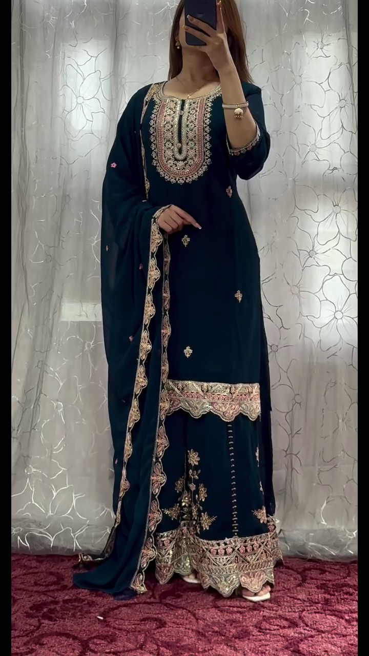 traditional outfit with intricate embroidery, giving off a royal and elegant vibe. The design's rich colors and detailed work are perfect for festive or formal occasions