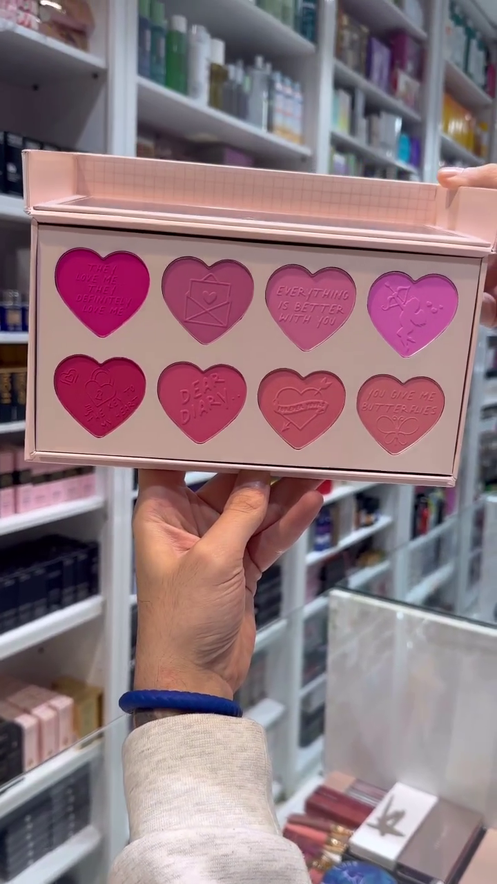 A cute blush palette featuring heart-shaped pans with different shades of pink, each embossed with charming messages. Perfect for adding a sweet and playful touch to your makeup look.