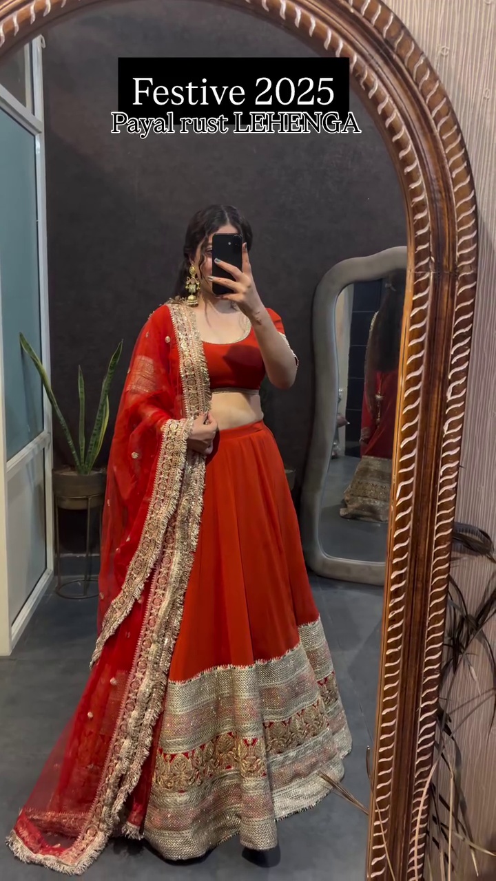 Festive Rust Payal Lehenga with Red Chiffon Dupatta and Intricate Golden Embroidery for a Stunning Traditional Look
