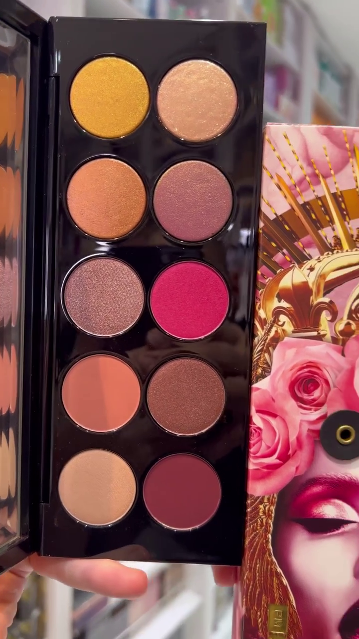This is a vibrant and stylish eyeshadow palette featuring rich, bold shades of pinks, purples, and warm tones. The packaging is eye-catching with an artistic design