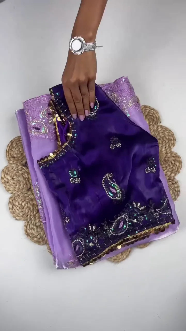 Stunning Lilac Sheer Organza Saree Featuring Intricate Thread Embroidery and Iridescent Sequins on the Border, Paired with a Rich Royal Purple Paisley Embroidered Blouse