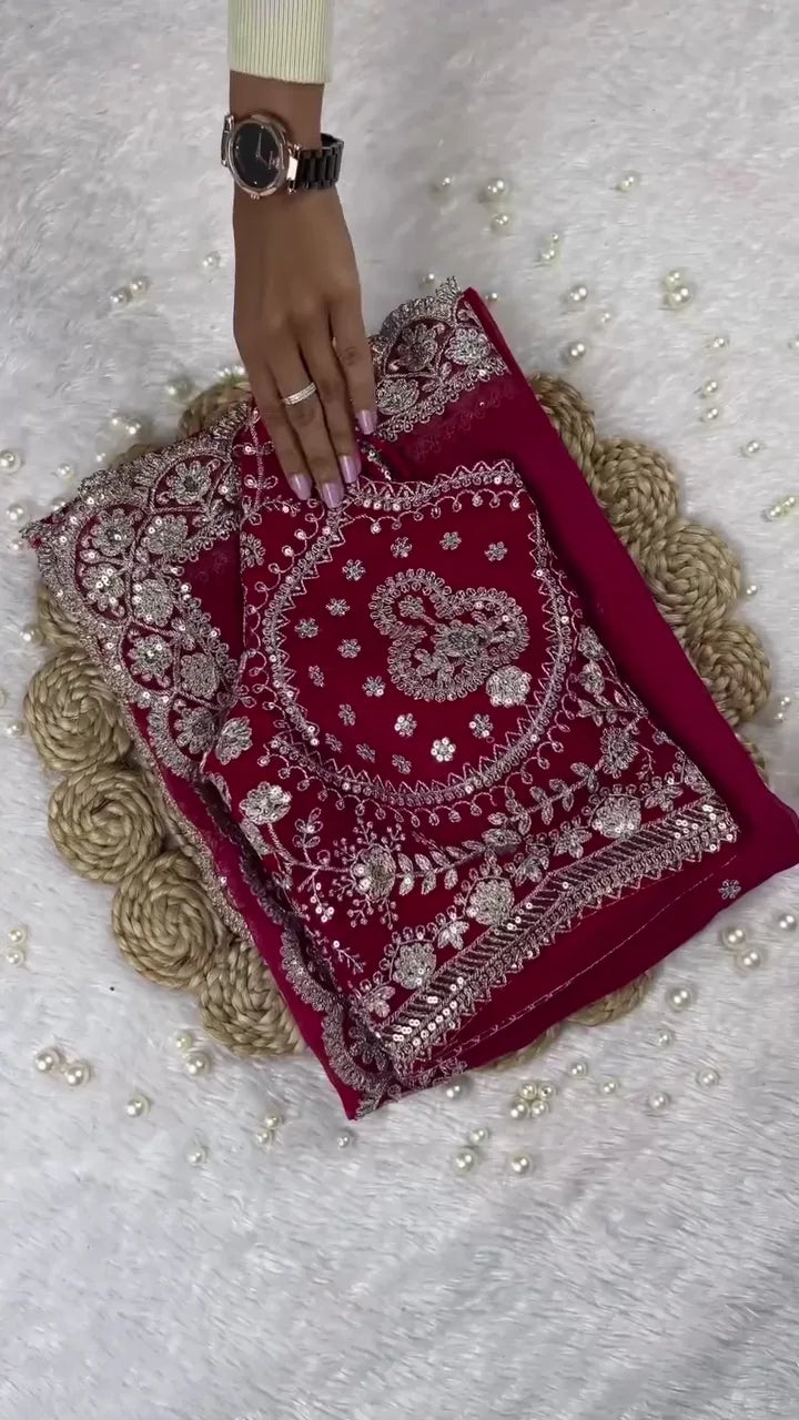 Deep Rani Pink Georgette Saree Ensemble Featuring a Heavily Embellished Blouse and Matching Dupatta Border Lavishly Adorned with Intricate Silver Zari Embroidery and Sparkling Stone Work