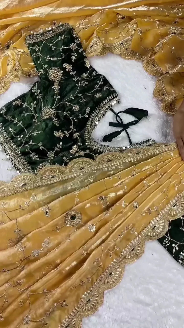 Mustard Yellow Velvet Saree Draped with Exquisite Silver Zari Embroidery and Mirror Work, Perfectly Complemented by a Rich Forest Green Velvet Blouse Featuring Matching Heavy Embellishments