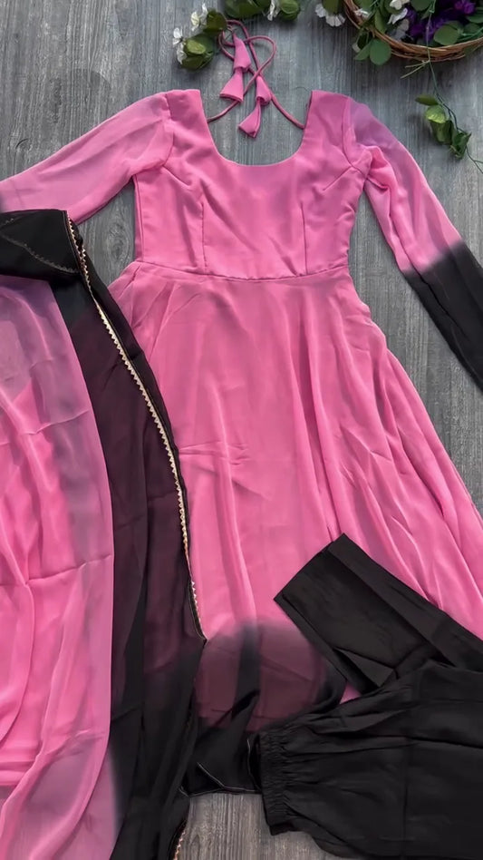Pink to Black Ombre Flowing Anarkali Suit Set Featuring a Scoop Neckline with Tie-Up Detail, Full Sleeves with Dip-Dye Effect, Matching Solid Black Trousers, and a Contrasting Pink and Black Dupatta