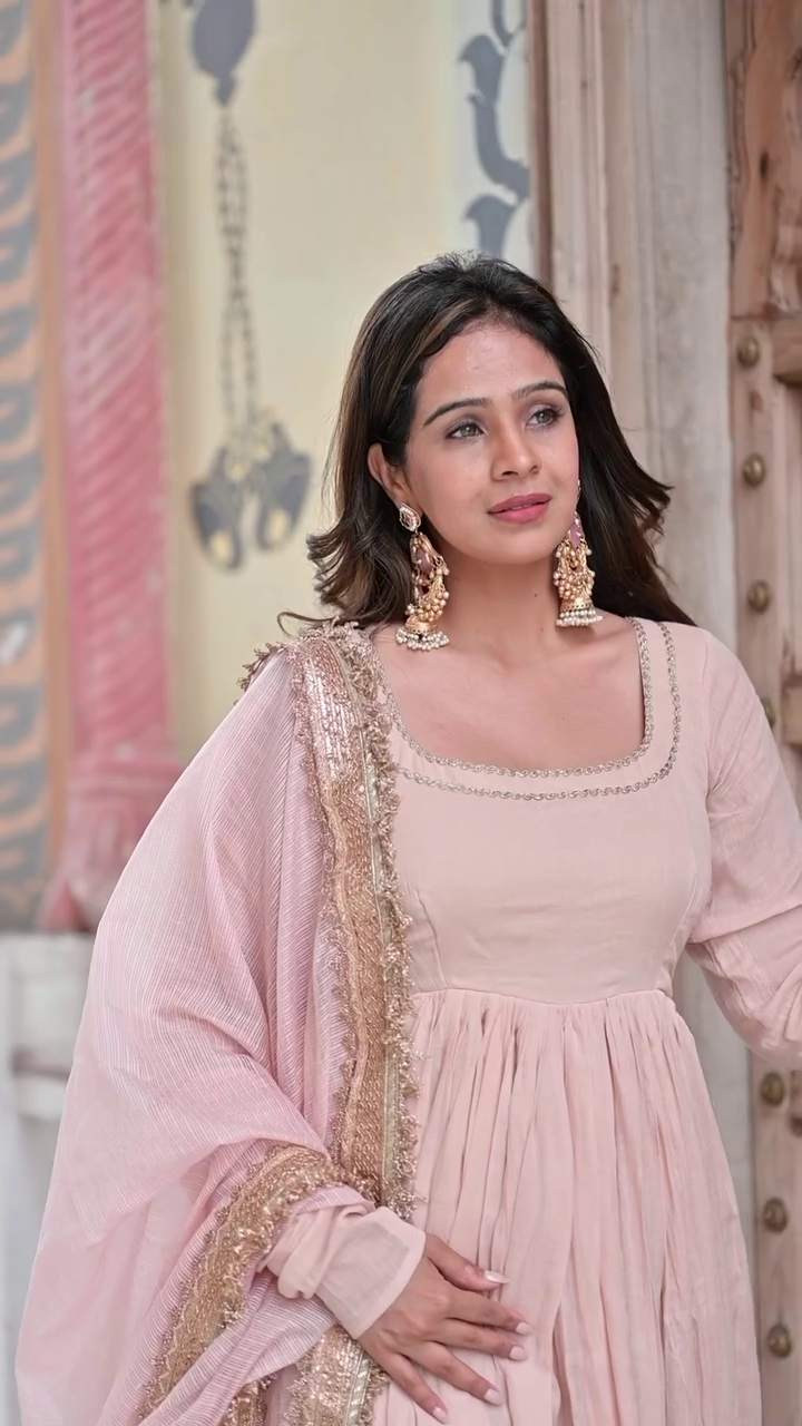 Peach Pink A-Line Anarkali Dress with Delicate Embroidered Borders and Soft Georgette Fabric, Perfect for Festive and Traditional Occasions