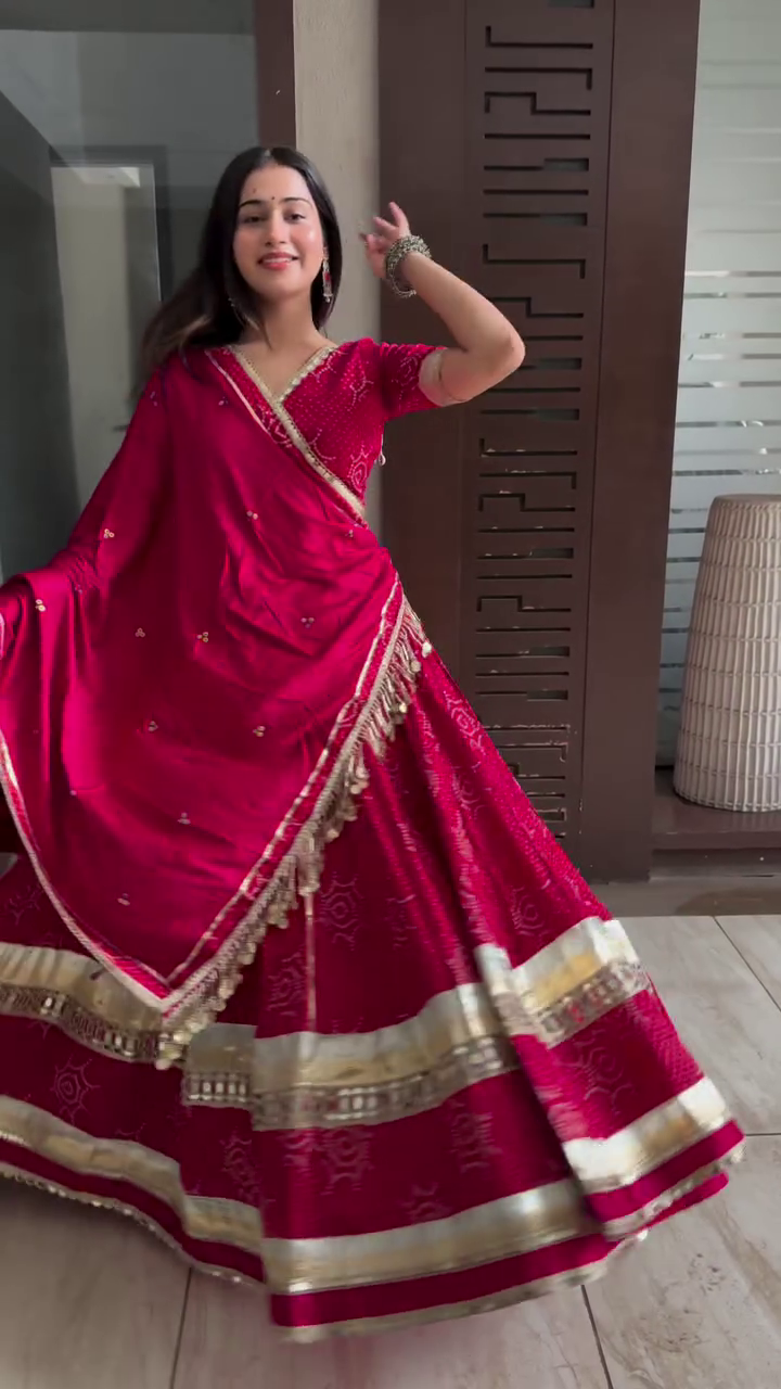 Elegant Red Embroidered Lehenga Choli with Tassel Detail and Traditional Gold Border for Festive Occasions and Weddings