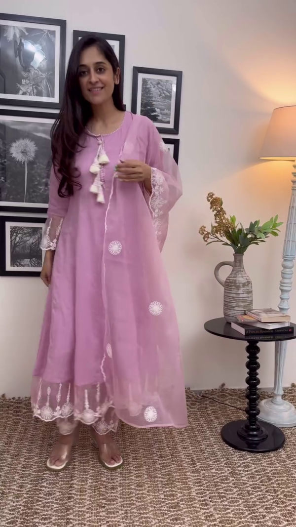 Mauve Pink Embroidered Anarkali Suit Set with Sheer Organza Dupatta, Delicate Lace Detailing on Sleeves and Hem, Paired with Matching Pants and Decorative Tassel Accents for a Graceful Festive Look