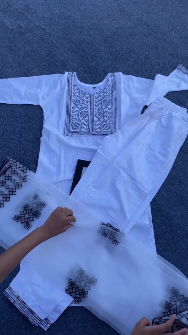 White Cotton Suit Set with Black Thread Embroidery on Kurta, Matching Pants, and Sheer Organza Dupatta Featuring Intricate Black Appliqué Work – Graceful Ethnic Wear