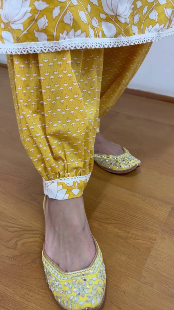 Bright Mustard Yellow Floral Printed Cotton Kurta Set for Women Featuring White Lotus Motif, Lace Detailing, Embroidered Neckline with Tassels, Matching Pants and Dupatta – Ideal for Festive and Everyday Ethnic Wear - Image 3