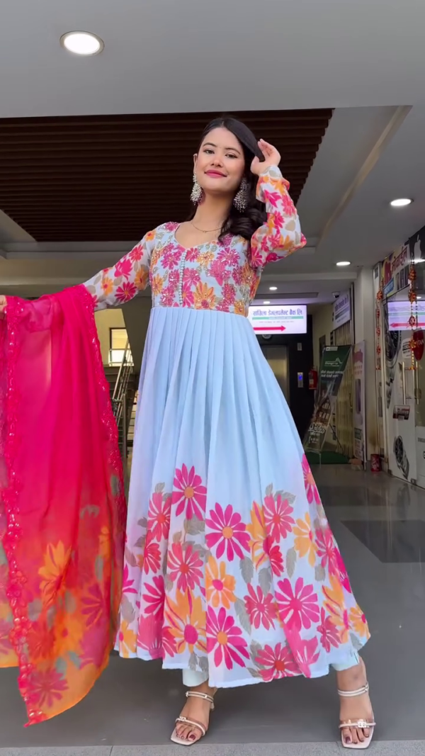 Sky Blue Floral Anarkali Dress with Vibrant Pink Embroidered Dupatta, Featuring Colorful Daisy Print, Intricate Thread Work, and Paired with Delicate Strappy Heels – Perfect for Festive Occasions and Traditional Celebrations